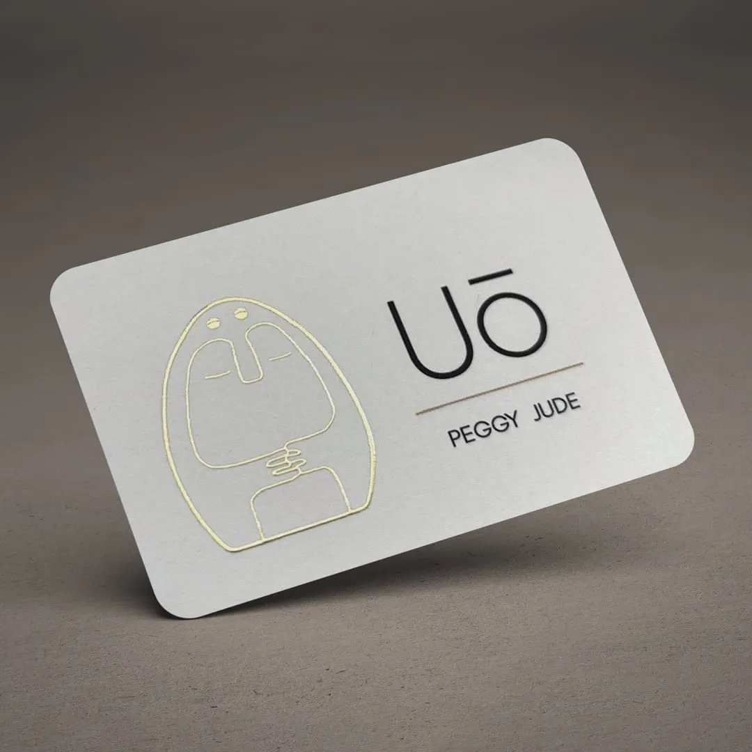Carte de visite blanche au logo doré, présentée en mise en situation
